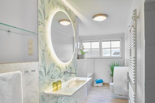 a bathroom with a sink and a mirror at Seeschloss Sellin in Ostseebad Sellin