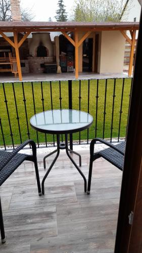 a table and two chairs on a patio at Kincsem Vendégház in Szilvásvárad