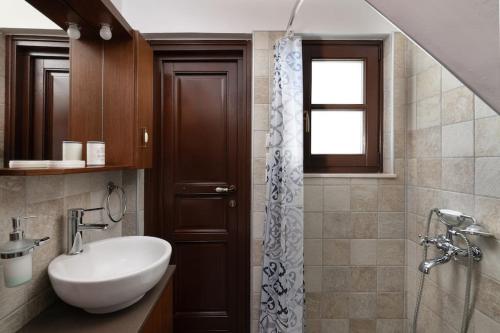 a bathroom with a sink and a shower at Genovefa traditional house in Koskinou