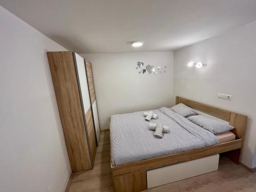 a bedroom with a bed with two candles on it at Apartment TiSa, Bled in Bled