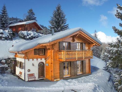 eine Blockhütte mit Schnee auf dem Dach in der Unterkunft Chalet Haute Vue in La Tzoumaz