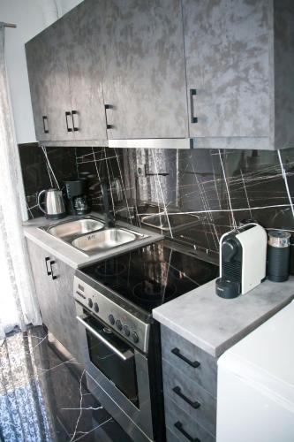 a small kitchen with a stove and a sink at Chris Luxury Studio in Ioannina