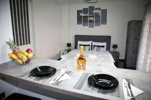 a table with two wine glasses and a bowl of fruit at Chris Luxury Studio in Ioannina