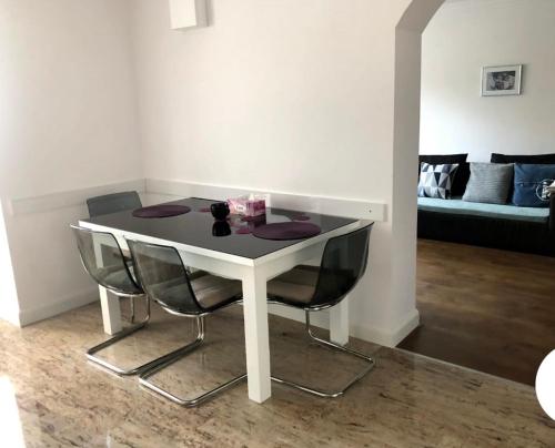 - une table et des chaises blanches dans le salon dans l'établissement Giovanni’s Home, à Sfântu-Gheorghe