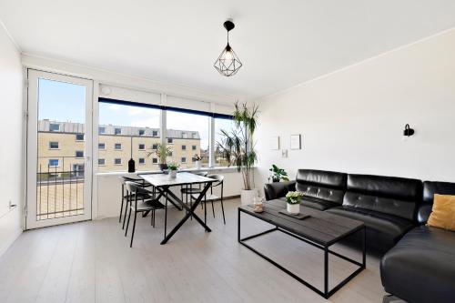 a living room with a couch and a table at Private Scandinavian Apartment in Randers