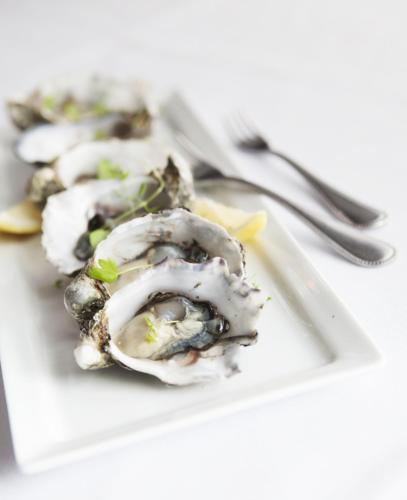 a plate of food with oysters on a table at Tuileries at De Bortoli Rutherglen in Rutherglen