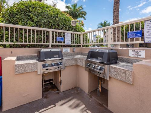 two bbq and grill equipment on a balcony at Pacific Shores A-105 - Ground Floor Family Condo in Kihei