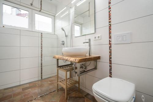 a bathroom with a sink and a toilet at Uferpromenade Whg OG in Röbel