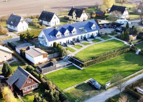 an aerial view of a large white house at Appartementanlage Zur Seemöwe in Insel Poel