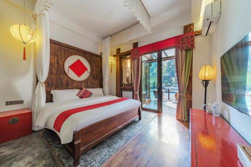 a bedroom with a large bed and a large window at Pandora Vista Retreat in Zhangjiajie