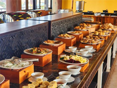 a buffet line with many plates of food at iHome Hoi An in Hoi An