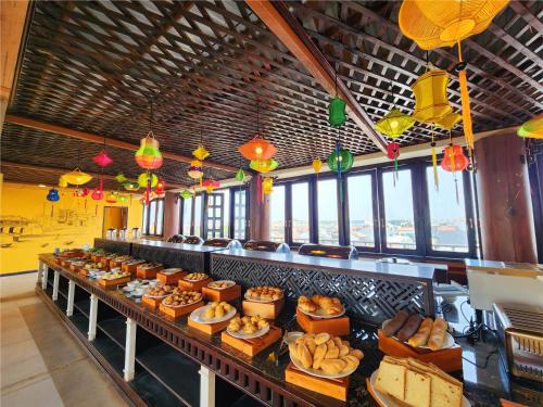 a buffet line with many plates of food and lights at iHome Hoi An in Hoi An