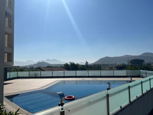 a swimming pool on the roof of a building at Rakabi The Fern, Igatpuri in Igatpuri