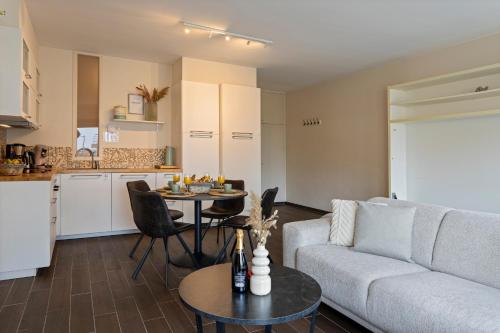 a living room with a couch and a table at Flat Marthe in Sint-Idesbald