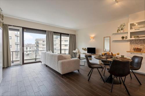 a living room with a couch and a table at Flat Marthe in Sint-Idesbald