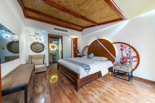 a bedroom with a large bed and a table at Pandora Vista Retreat in Zhangjiajie