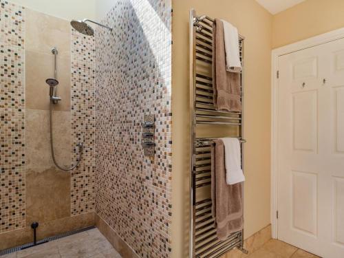 a bathroom with a shower and a walk in shower at Rivendell Lodge in East Winch