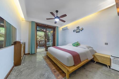 a bedroom with a bed and a ceiling fan at Pandora Vista Retreat in Zhangjiajie