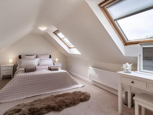 um quarto com uma cama grande e uma janela em Rivendell Lodge em East Winch