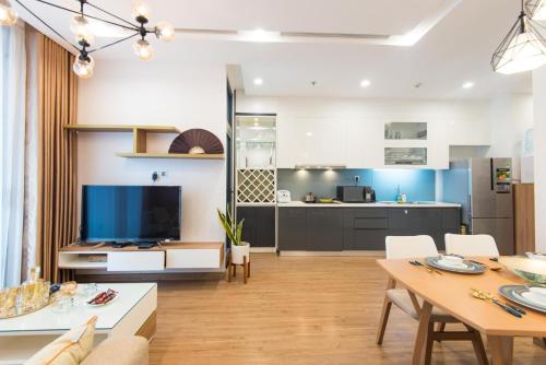 a kitchen and a living room with a dining room at Premium Apartment Vinhomes Metropolis BaDinh in Hanoi