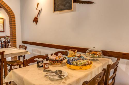 a table with a white table cloth and bowls of food at Agriturismo Pozzo Fiorito in Castiglione delle Stiviere