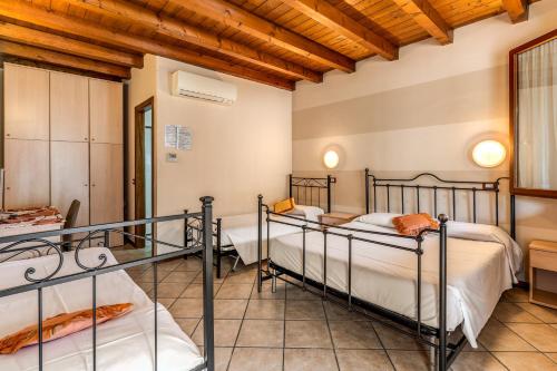 a bedroom with four bunk beds in a room at Agriturismo Pozzo Fiorito in Castiglione delle Stiviere