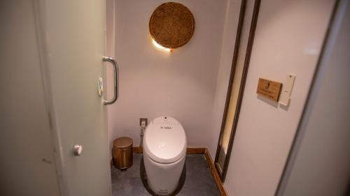 a bathroom with a white toilet in a room at Pandora Vista Retreat in Zhangjiajie