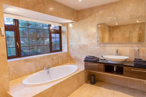 a large bathroom with a tub and a sink at The Lodge at Highlands 