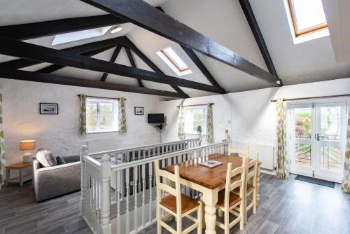 a kitchen and living room with a wooden table at Tregenna Castle Resort in St Ives