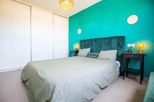 a bedroom with a large bed with a blue wall at 3083 Casa Nueve in San Pedro del Pinatar