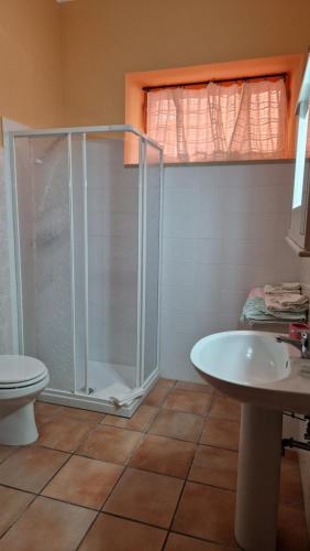 a bathroom with a shower and a toilet and a sink at Casa Mirella in Bolsena