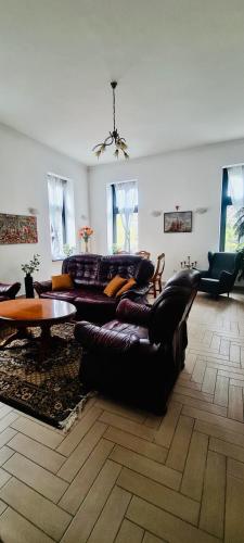 a living room with a couch and a table at City center apartment in Sopron