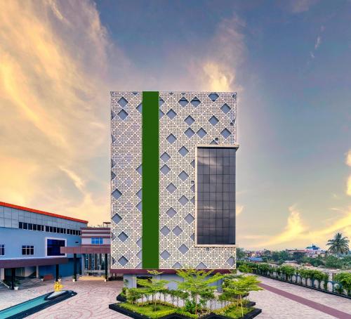 a building with a green and white facade at Soaltee Westend Itahari in Itahari