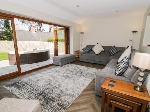 a living room with a couch and a table at Y Gorlan in Conwy