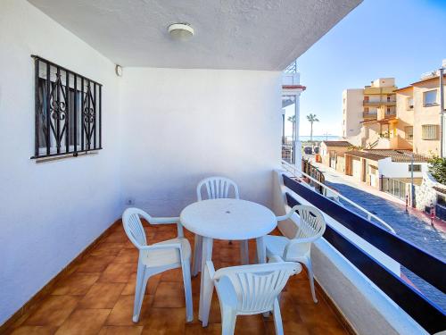 a table and chairs on a balcony with a view at Playa de Peñíscola - Ideal familias 6-7 pax o Parejas 2-4 pax - terraza - parking in Peniscola
