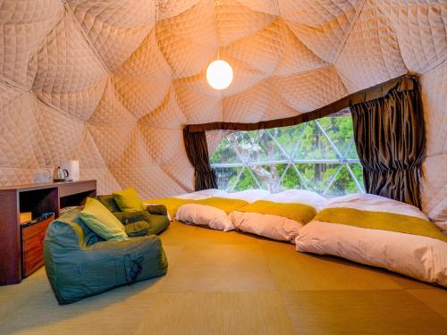 a room with a tent with four beds and a window at Lupo Forest "GRAN FOREST Echizen Miyama" - Vacation STAY 07099v in Fukui
