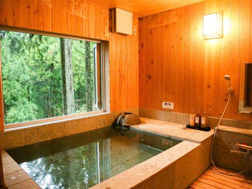 a swimming pool in a room with a window at Lupo Forest "GRAN FOREST Echizen Miyama" - Vacation STAY 07099v in Fukui