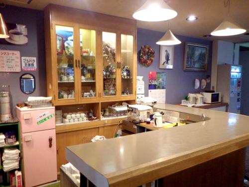 a kitchen with a counter and a counter top at Hotel Masyu in Teshikaga