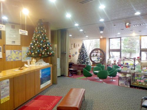 a store with two christmas trees in a room at Hotel Masyu in Teshikaga