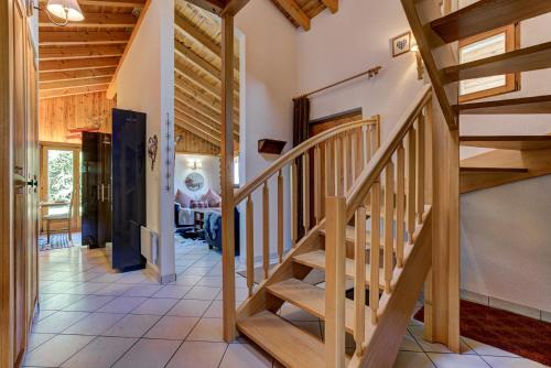 a staircase in a house with wooden ceilings at Chalet Khione in La Tzoumaz