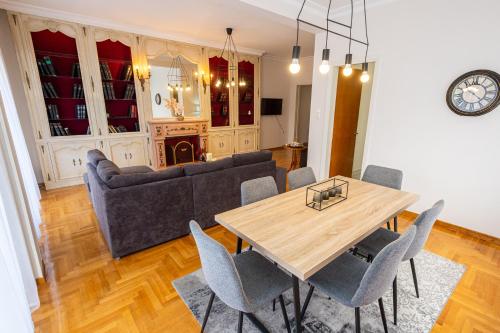 a living room with a table and a couch at Square 119 in Volos