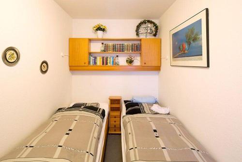シャルボイツにあるFerienwohnung-207-im-Berliner-Hofの小さなお部屋で、ベッド2台、棚が備わります。