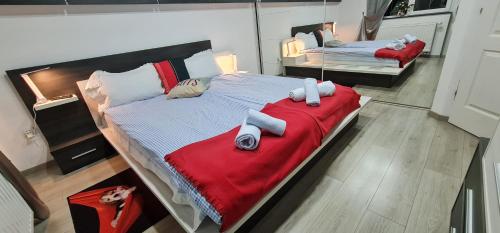 a large bedroom with two beds with red blankets at MeLux Airport House 