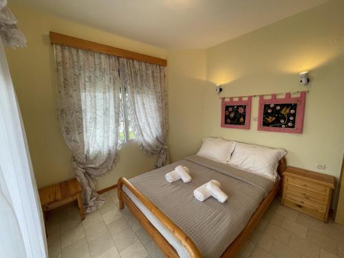 a bedroom with a bed with two towels on it at Maisonette by the sea in Keramotí