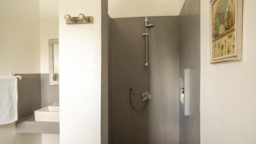 a bathroom with a shower and a sink at Casamia Suites in Diani Beach