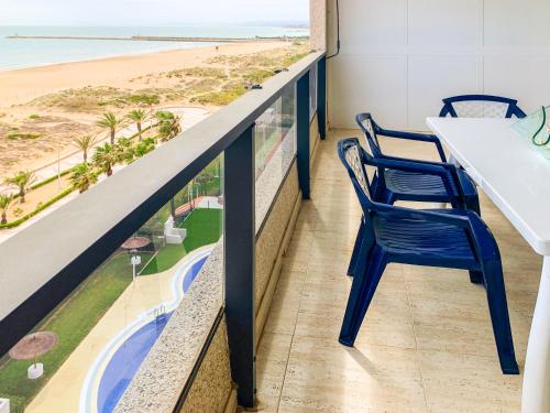 a balcony with chairs and a view of the beach at ESPACIO 8 - Primera Línea de Playa in Cullera