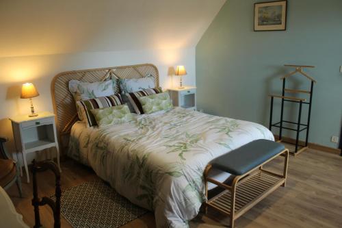 a bedroom with a large bed and a chair at ROC callac in Saint-Gilles-du-Vieux-Marché