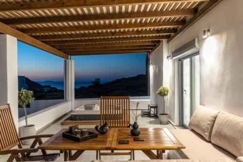 a living room with a wooden table and chairs at Casa Aelia ,Stelida Naxos in Stelida