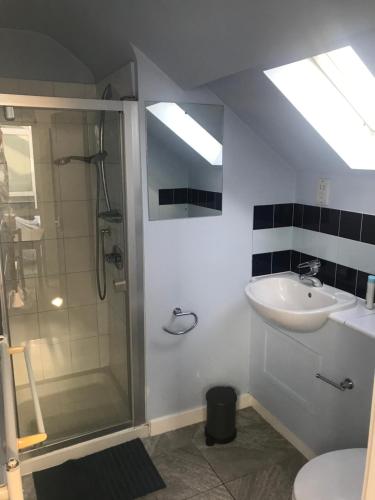 a bathroom with a sink and a shower at Hendon Central, Private room ensuite in London