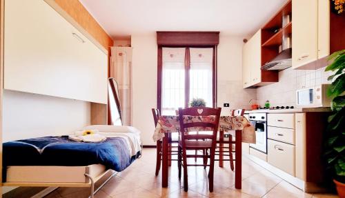 a kitchen with a table and chairs in a room at Guest Holiday Filangieri 1 in Reggio Emilia